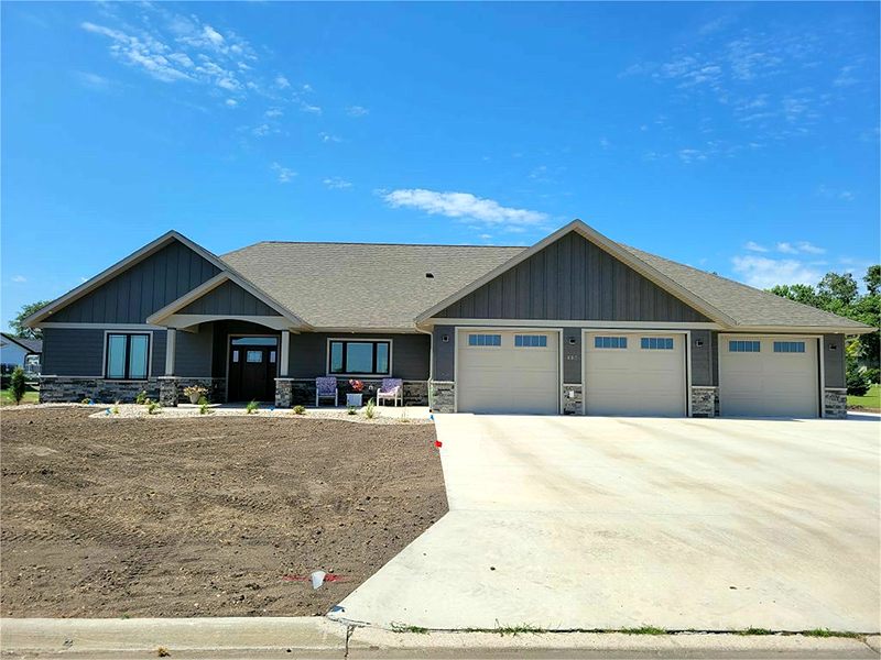 Blue-gray ranch with stone accents and a three-stall garage