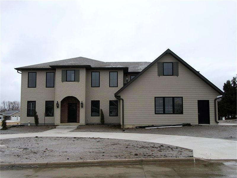 Two-story home with an arched entry