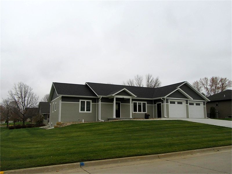 Gray ranch home with a three-stall garage