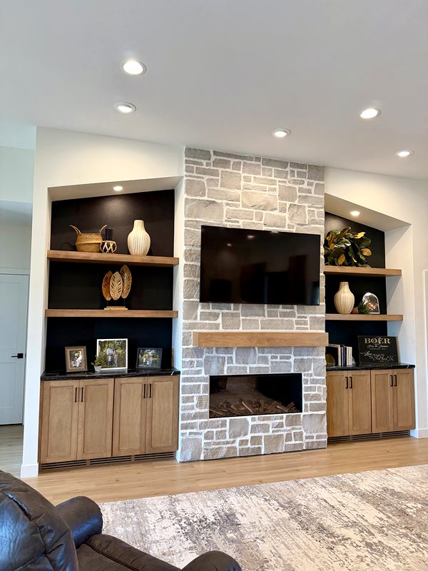 Stone fireplace surround with built-in cabinets