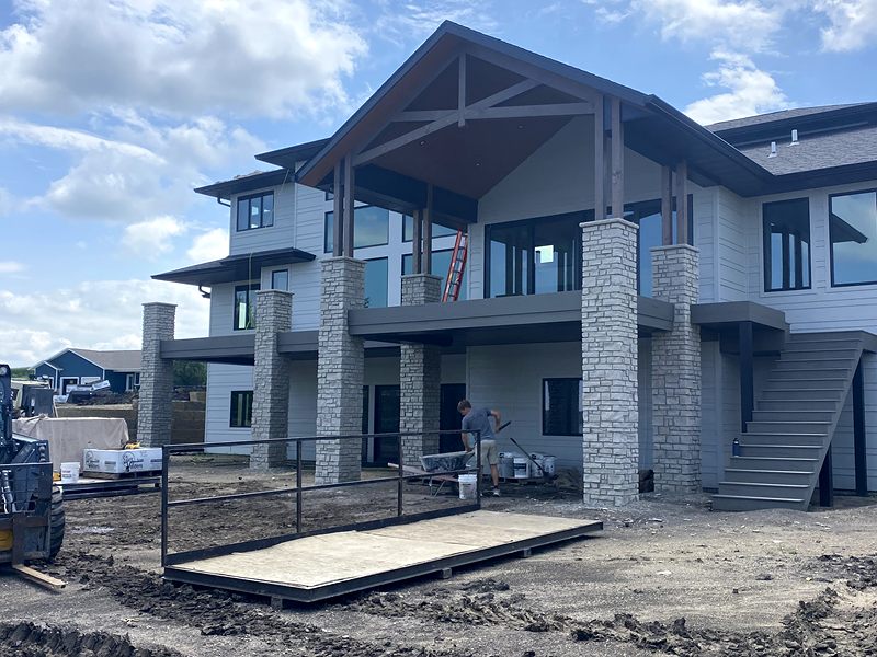 Stone-wrapped columns under a new rear deck